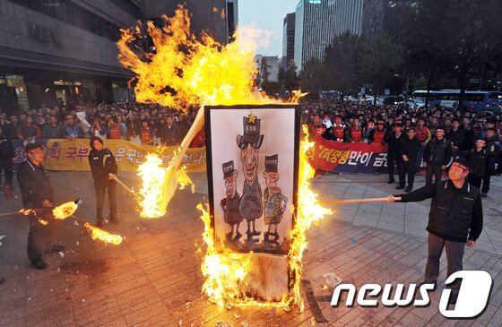 본문 이미지 - 외환은행 노동조합 주최로 23일 오후 서울 명동 외환은행 본점 앞에서 외환은행 사수와 론스타 규탄을 위해 열린 '론스타 징벌매각 촉구 8천직원 총진군대회'에서 참가자들이 상징의식으로 론스타 등 투기자본에 대한 화형식을 하고 있다.