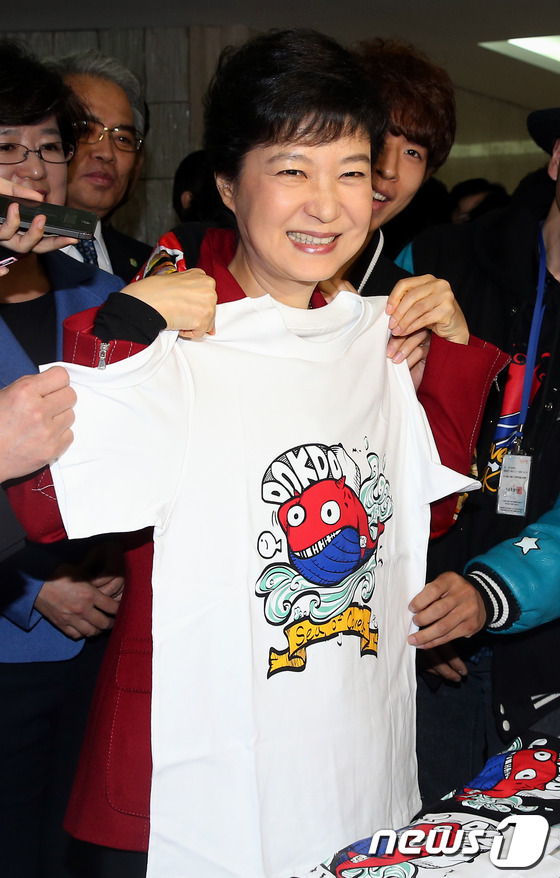 (서울=뉴스1) 양동욱 기자 = 새누리당 박근혜 대선 후보가 7일 오후 서울 중구 태평로 프레스센터에서 열린 여성유권자연맹 해피바이러스 콘서트에 참석하며 입구에서 판매중인 태극독도 …