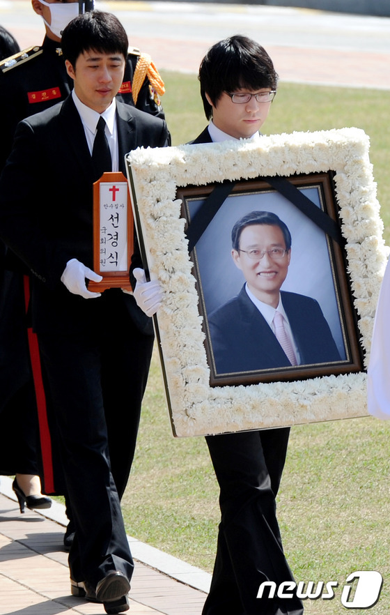 (서울=뉴스1) 박정호 기자 = 30일 오전 서울 여의도 국회 정현관에서 엄수된 창조한국당 고 선경식 의원의 국회장 영결식에서 유가족들이 고인의 영정을 모시고 있다. 2012.4. …