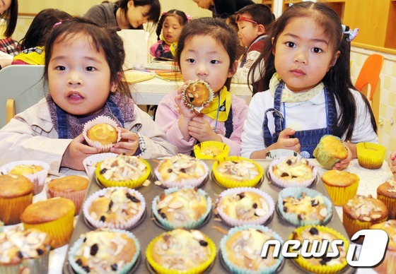 (서울=뉴스1) 이정선 인턴기자 = 6일 오전 서울 용산구 숙명여대에서 열린 다문화가족 한국음식 요리체험 행사에서 다문화가족 어린이들이 직접 만든 머핀을 내보이고 있다. 이번 행사 …