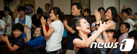 (서울=뉴스1) 김성광 인턴기자 = 17일 오후 서울 중구 을지로2가 향린교회에서 열린 ‘구럼비를 사랑한 별이의 노래’ 북 콘서트에서 가수 이은미가 열창하고 있다. 변영주영화 감독 …