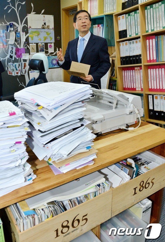 (서울=뉴스1) 이명근 기자 = 박원순 서울시장이 24일 오전 서울시청 신청사 집무실로 출근해 재활용 재료를 이용해 만든 책장을 소개하고 있다. 2012.9.24/뉴스1