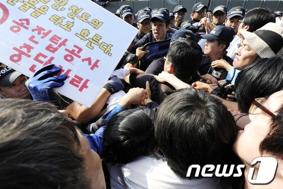 본문 이미지 - 밀양 송전탑 공사재개 이틀째인 2일 오후 밀양 단장면 단장리 765㎸ 신고리-북경남 송전선로 건설공사 4공구 현장사무소 앞에서 송전탑 반대 주민들과 집회 참가자들이 경찰과 몸싸움을 벌이고 있다. 2013.10.3/뉴스1 © News1 전혜원 기자