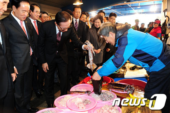 (포항=뉴스1) 최창호 기자 = 13일 이명박 전 대통령 내외가 퇴임 후 고향인 경북 포항을 찾았다.죽도어시장을 찾은 이 전 대통령이 오징어를 구입하고 있다. 이에 앞서 이 전대통 …