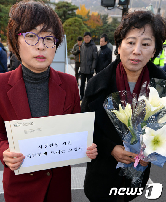 (서울=뉴스1) 정회성 기자 = 민주당 은수미(왼쪽), 남윤인순 의원이 17일 오후 '시정연설 관련 대통령께 드리는 요청서'와 진실을 상징하는 백합꽃을 청와대에 전달하기 위해 서울 …
