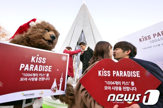 본문 이미지 - 28일 오전 서울 중구 남산 N서울타워에서 열린 &#39;N타워 키스 파라다이스-1004의 키스&#39; 이벤트 행사에서 모델들이 키스타임을 연출하고 있다. N타워 키싱트리에서 연인이나 가족이들이 다양한 방법으로 키스를 할 때마다 1인당 1004원의 기부금이 자동 적립되며 참가자가 1004명이 넘어서면 적립된 기부금은 CJ도너스캠프를 통해 중국농민공학교 어린이들을 위한 꿈나무음악교실에 지원된다.2013.11.28/뉴스1 © News1   최영호 기자