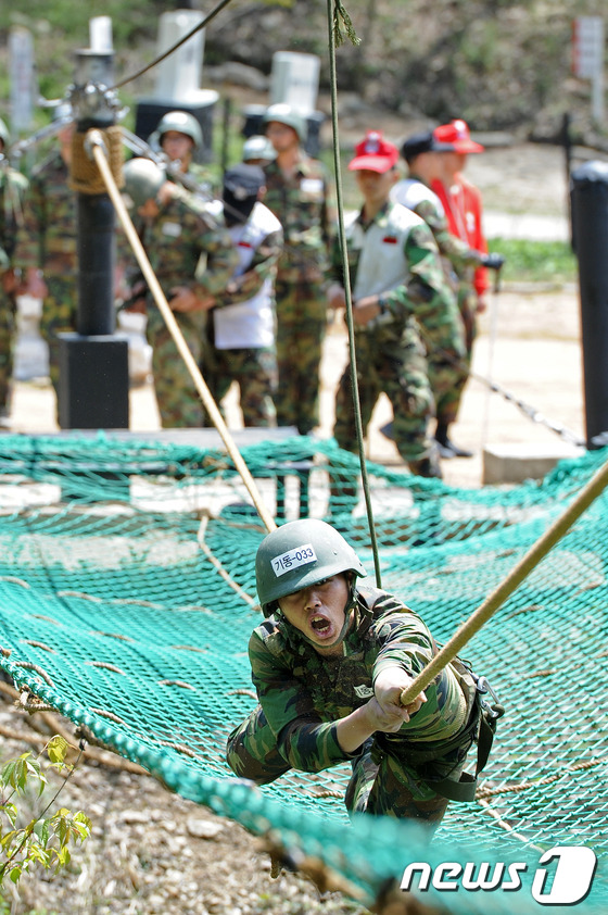 (완주=뉴스1) 김대웅 기자 = 30일 육군35사단 장병들이 전북 완주군 용진면 충경유격장에서 외줄타기 훈련을 받으며 자신과의 싸움을 하고 있다.2013.04.30/뉴스1