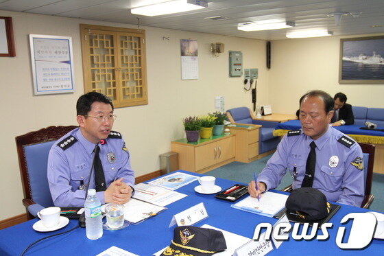 본문 이미지 - 김석균 해경청장(왼쪽)이 구관호 군산해경서장에게 불법조업 외국어선에 대한 강력한 단속을 주문하고 있다. © News1 