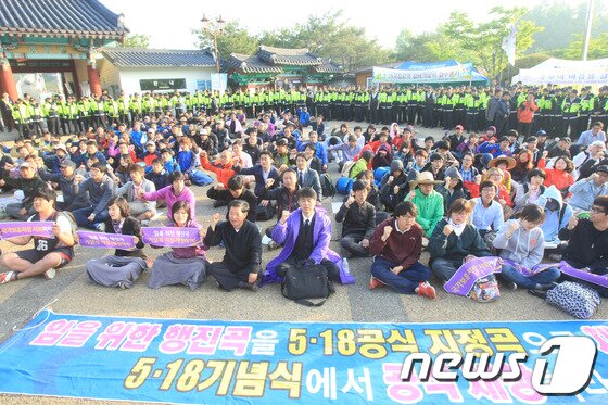 본문 이미지 - 5·18 제33주년 기념식이 열리는 18일 오전 광주시 북구 운정동 국립5·18민주묘지에서 '임을 위한 행진곡' 제창 촉구 집회가 열리고 있는 가운데 경찰 병력이 이를 둘러싸 지켜보고 있다. 2013.5.18/뉴스1 © News1 김태성 기자