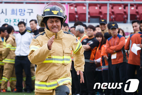 (서울=뉴스1) 유승관 기자 = 서울시 의용소방대원들이 20일 오전 서울 잠실 종합운동장 보조경기장에서 의용소방대 창설 77주년을 맞아 열린 '2013 종합소방기술경연대회'에서 개 …
