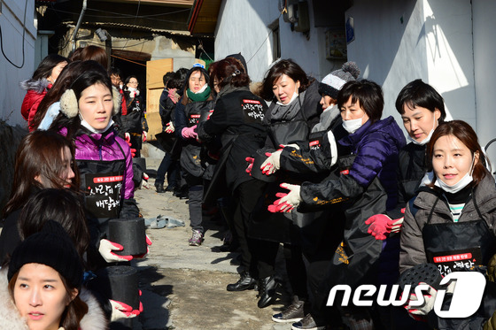 (서울=뉴스1) 민경석 기자 = 1일 오후 서울 노원구 상계동 일대에서 결혼정보업체 듀오 임직원들이 소외이웃들에게 전달될 연탄을 나르고 있다.이날 행사는 3만 명 성혼 고객 탄생을 …