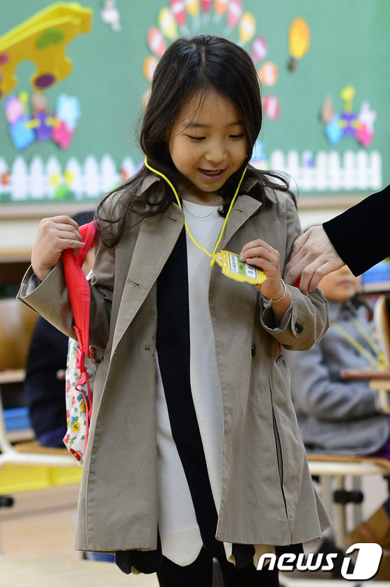(서울=뉴스1) 박지혜 기자 = 3일 오전 서울 종로구 교동초등학교에서 열린 입학식에서 한 신입생 어린이가 명찰을 보며 신기해 하고 있다.2014년도 종로구 교동초등학교의 입학생 …