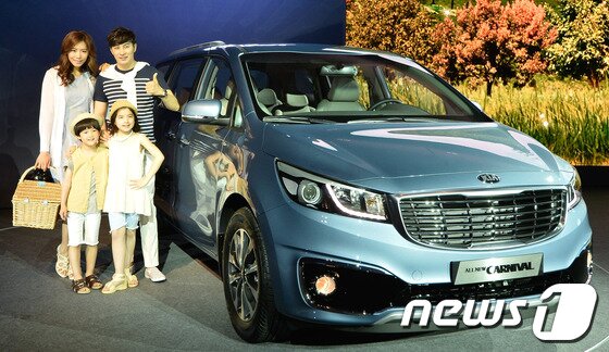 본문 이미지 - 오는 6월 출시 예정인 기아자동차의 3세대 '올 뉴 카니발'이 22일 오전 서울 광진구 W호텔에서 공개된 가운데 가족 모델들이 포즈를 취하고 있다.올 뉴 카니발은 이전 모델에 비해 더욱 세련되고 볼륨감 있는 스타일의 디자인으로 재탄생했으며, 세계 최초로 4열 팝업 싱킹 시트를 적용하고 보조 시트 개선 등을 통해 실용적인 디자인까지 갖췄다. 2014.5.22/뉴스1 © News1   송은석 기자
