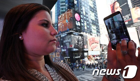 본문 이미지 - 지난 4월 말 미국 뉴욕 맨하탄 내 세계 최대 가전매장인 베스트바이를 찾은 고객들이 LG TV 부스에서 스마트폰과 연동해 다양한 프로그램을 체험하고 있다. 2014.6.12/뉴스1 © News1   (뉴욕(미국)=뉴스1) 허경 기자