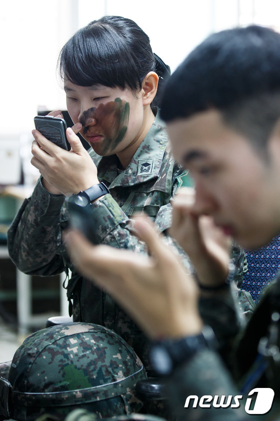 (철원=뉴스1) 유승관 기자 = 최초 여군 포병장교 홍지혜(25·육사70기) 소위가 17일 강원도 철원군 6사단 포병대대 전술훈련에서 위장크림을 바르고 있다. 올해부터 육군의 포병 …