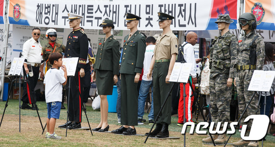 (서울=뉴스1) 유승관 기자 = 28일 서울광장에서 제64주년 서울수복 기념 행사 일환으로 열린 해병대 수색대특수장비 및 장비전시 체험 부스에서 한 어린이가 해병대 복장을 살펴보고 …