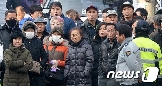 경기도 안산시 상록구 본오동 주민들이 19일 오전 &#39;안산 인질극&#39; 피의자 김상훈이 범행현장검증을 위해 범행 장소에 들어가는 모습을 지켜보고 있다. 피의자는 지난 13일 안산시 본오동 가정집에서 인질극을 벌이며 부인의 전남편을 비롯해 두명을 살해했다. 2015.1.19/뉴스1 ⓒ News1 이재명 기자