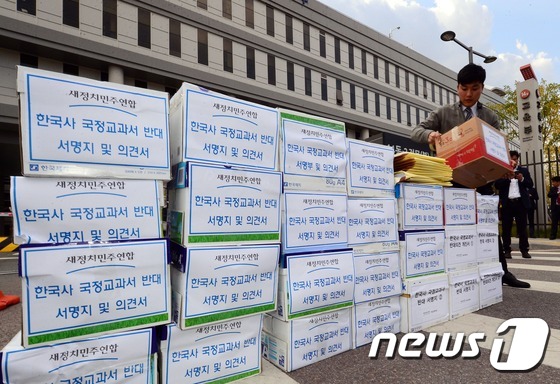 (세종=뉴스1) 장수영 = 새정치민주연합 관계자들이 2일 정부세종청사 교육부 정문에서 교육부에 전달할 국정화 역사교과서 반대 서명지 및 의견서를 옮기고 있다. 2015.11.2/뉴 …