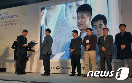 본문 이미지 - 충북 영동군 황간면 월류원의 박천명 대표가 28일 ‘2016 대한민국 우리 술 품평회’에서 과실주 부문 우수상을 받고 있다.(영동군 제공).2016.12.28.ⓒ News1