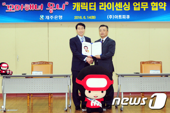 (제주=뉴스1) 이석형 기자 = 14일 제주은행(행장 이동대·왼쪽)은 제주시 이도동 제주은행 본점 4층 대회의실에서 ㈜아트피큐(대표 오태헌)와 ‘꼬마해녀 몽니’ 캐릭터 라이센싱 업 …