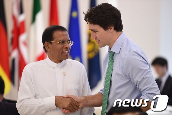 본문 이미지 - 마이트리팔라 시리세나 스리랑카 대통령(왼쪽)이 지난달 27일 일본 미에현에서 열린 선진 7개국(G7) 정상회의 확대회의에 참석, 저스틴 트뤼도 캐나다 총리와 악수하며 인사를 나누고 있다. ⓒ AFP=뉴스1