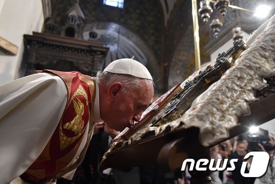 (예레반 AFP=뉴스1) 김혜지 기자 = 프란치스코 교황이 24일(현지시간) 아르메니아 수도 예레반의 사도교회를 방문해 성경에 경건히 입맞춤 하고 있다.ⓒ AFP=뉴스1