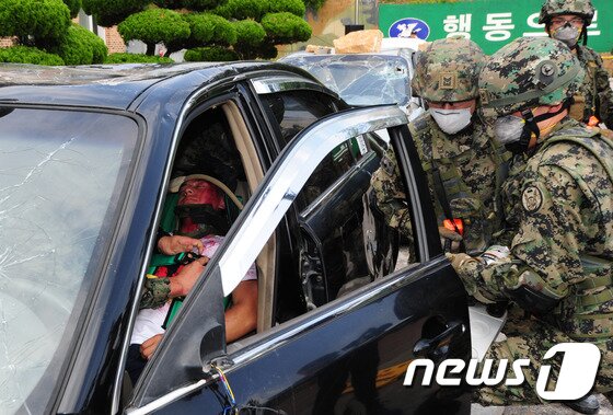 본문 이미지 - 30일 오후 전북 익산시 제7공수여단에서 실시한 재난구조부대 임무수행능력 평가 중 특전사 구조대가 차안에 갇힌 사람을 구하기 위해 차문을 해체하고 있다.2016.6.30/뉴스1 ⓒ News1 문요한 기자