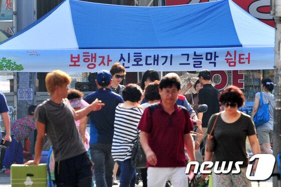 본문 이미지 - 전국에 폭염특보가 발령된 12일 경북 포항시가 시민들의 건강을 위해 관내 주요 횡단보도에 그늘막을 설치해 운영 중이다.2016.8.12/뉴스1 ⓒ News1 최창호 기자