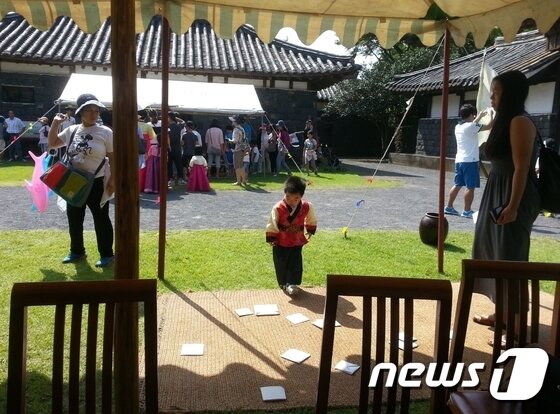 본문 이미지 - 제주민속촌 내에서 딱지치기를 하는 모습. (제주민속촌 제공) 2016.09.12/뉴스1 ⓒ News1