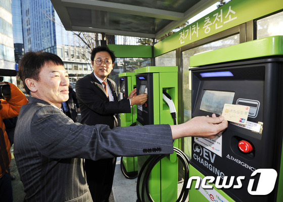 (서울=뉴스1) = 이정섭 환경부 차관(오른쪽)과 채종진 BC카드 부사장이 11일 서울 종로구 열린마당 공영주차장에서 열린 '전기자동차 충전요금 할인을 위한 업무협약식'에서 그린카 …