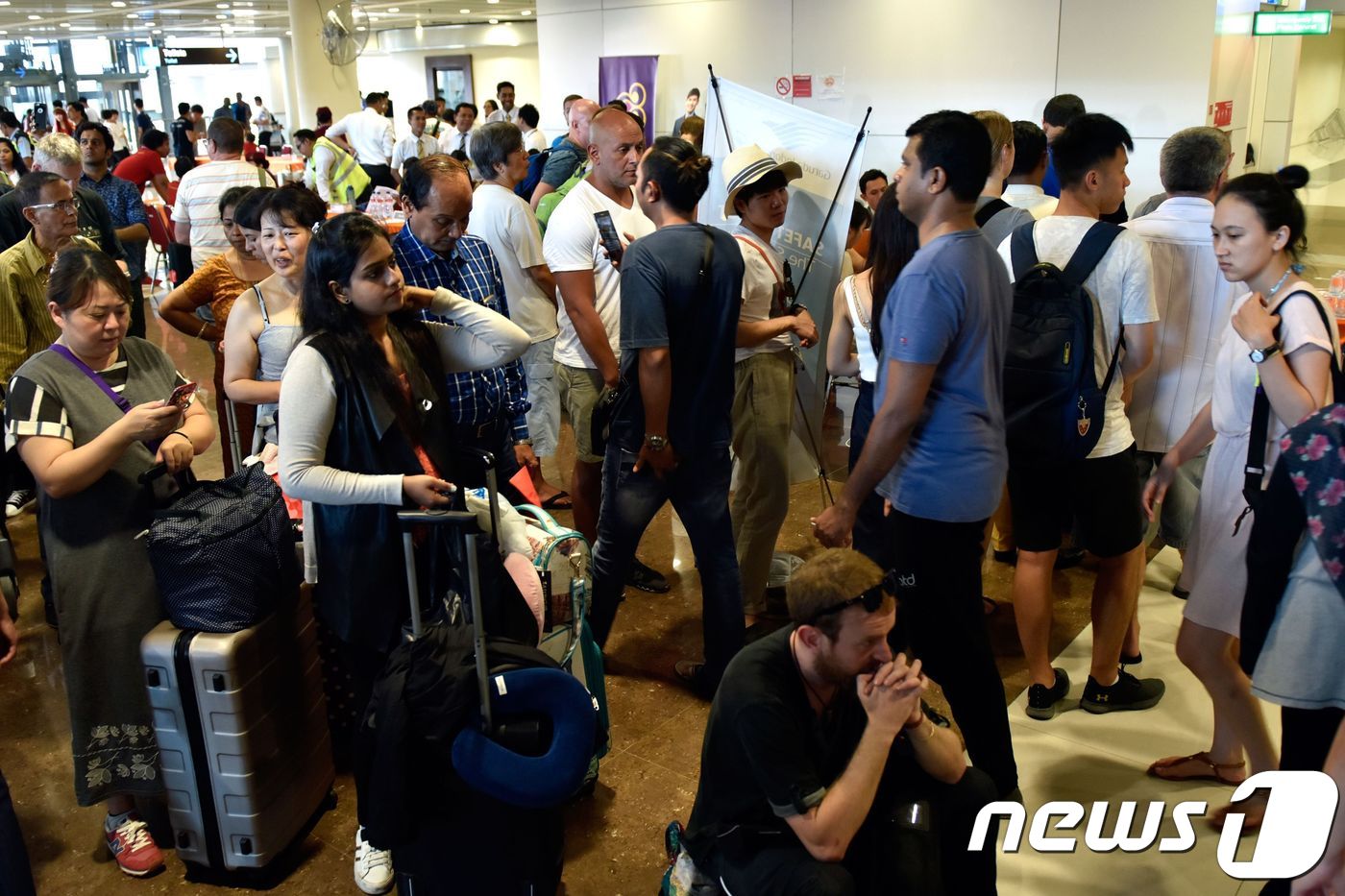 (덴파사르 AFP=뉴스1) 우동명 기자 = 27일(현지시간) 인도네시아 발리 섬 아궁화산 분화로 잠정 폐쇄된 덴파사르의 응우라라이 국제공항에 발이 묶인 여행객들이 만원을 이루고 있 …