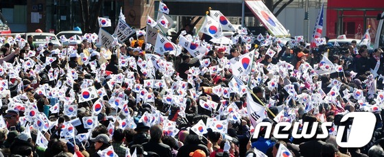 (부산=뉴스1) 여주연 기자 = 박근혜 대통령 탄핵심판 선고일을  하루 앞둔 9일 오후 부산 동구 초량동 부산역 광장에서 열린 '탄핵 각하 촉구 집회'에서 참가자들이 태극기를 흔들 …