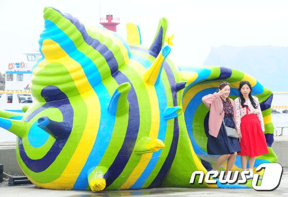 본문 이미지 - 21일 제주시 우도에서 개막한 제9회 우도소라축제에서 관광객들이 대형 소라 조형물 앞에서 기념사진을 촬영하고 있다.2017.4.21/뉴스1 ⓒ News1 이석형 기자