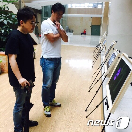 본문 이미지 - 경기도교육청 북부청사 1층 로비에 전시된 사진작품을 감상하는 시민들 ⓒ News1