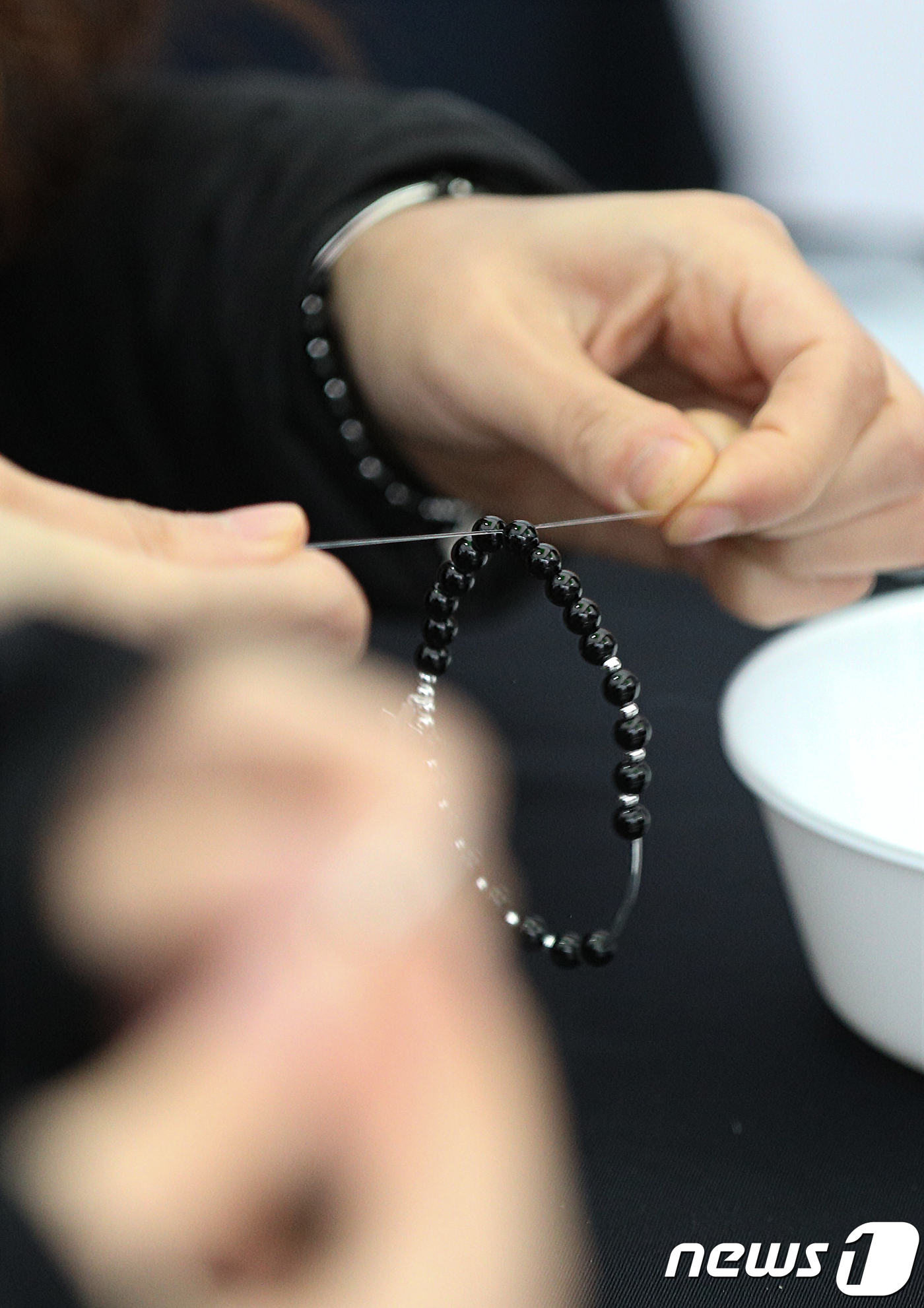 (서울=뉴스1) 신웅수 기자 = 24일 오후 서울 청계광장에서 열린 대한민국 종교문화 축제 천주교 부스에서 시민들이 묵주를 만들고 있다.각 종교의 특색과 문화가 소개된 이번 축제에 …