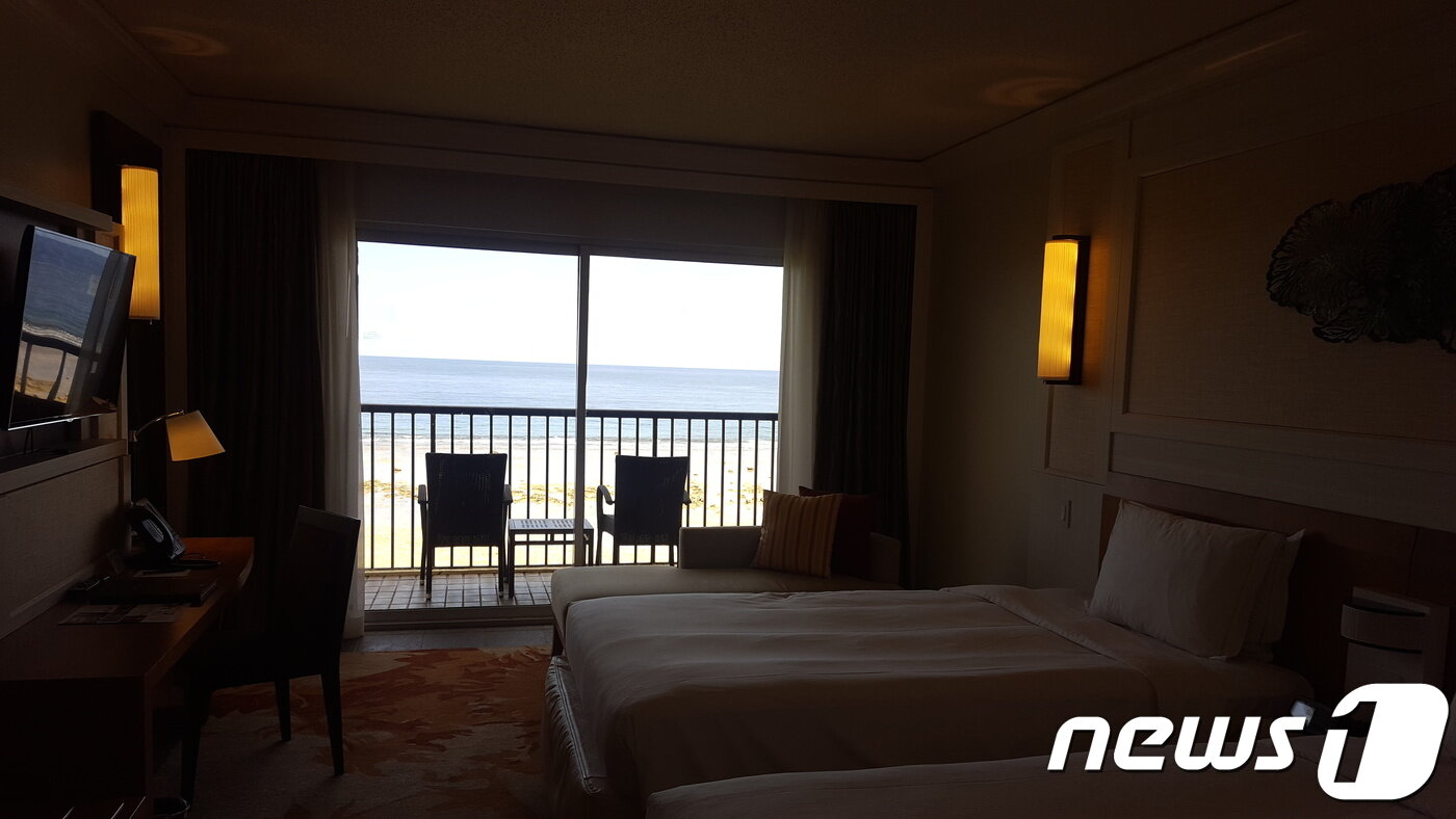 본문 이미지 - 힐튼 괌 호텔 객실 내부. 창 밖 테라스 너머로 투몬만이 보인다. ⓒ News1 문창석 기자