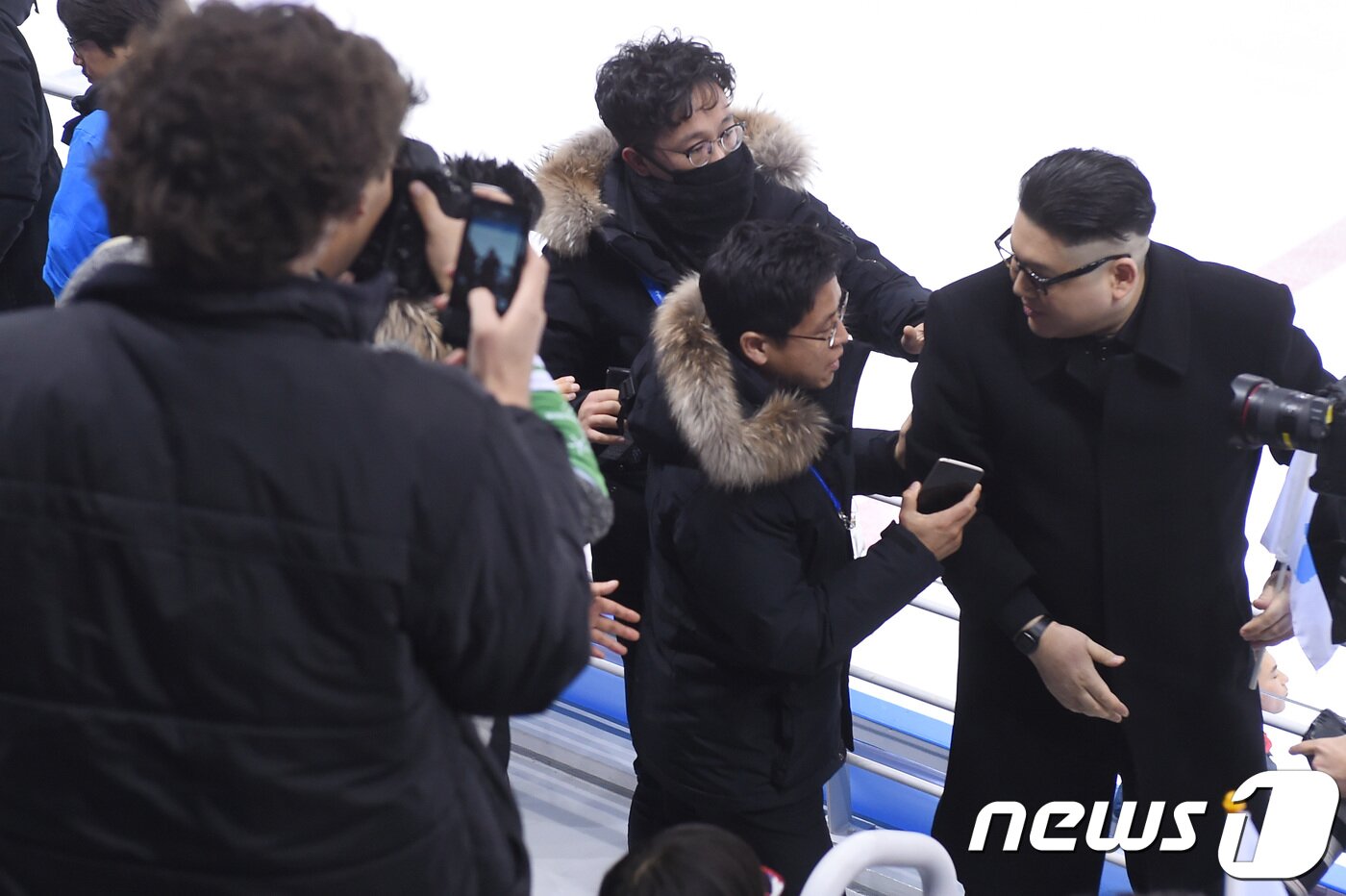 본문 이미지 - 14일 오후 강원도 강릉 관동하키센터에서 열린 2018 평창동계올림픽 여자 아이스하키 B조 조별리그 3차전 단일팀과 일본과 경기에서 북한 김정은 노동당 위원장을 코스프레한 닮은꼴이 나타나 응원을 펼치자 제지를 받고 있다. 2018.2.14/뉴스1 ⓒ News1 임세영 기자
