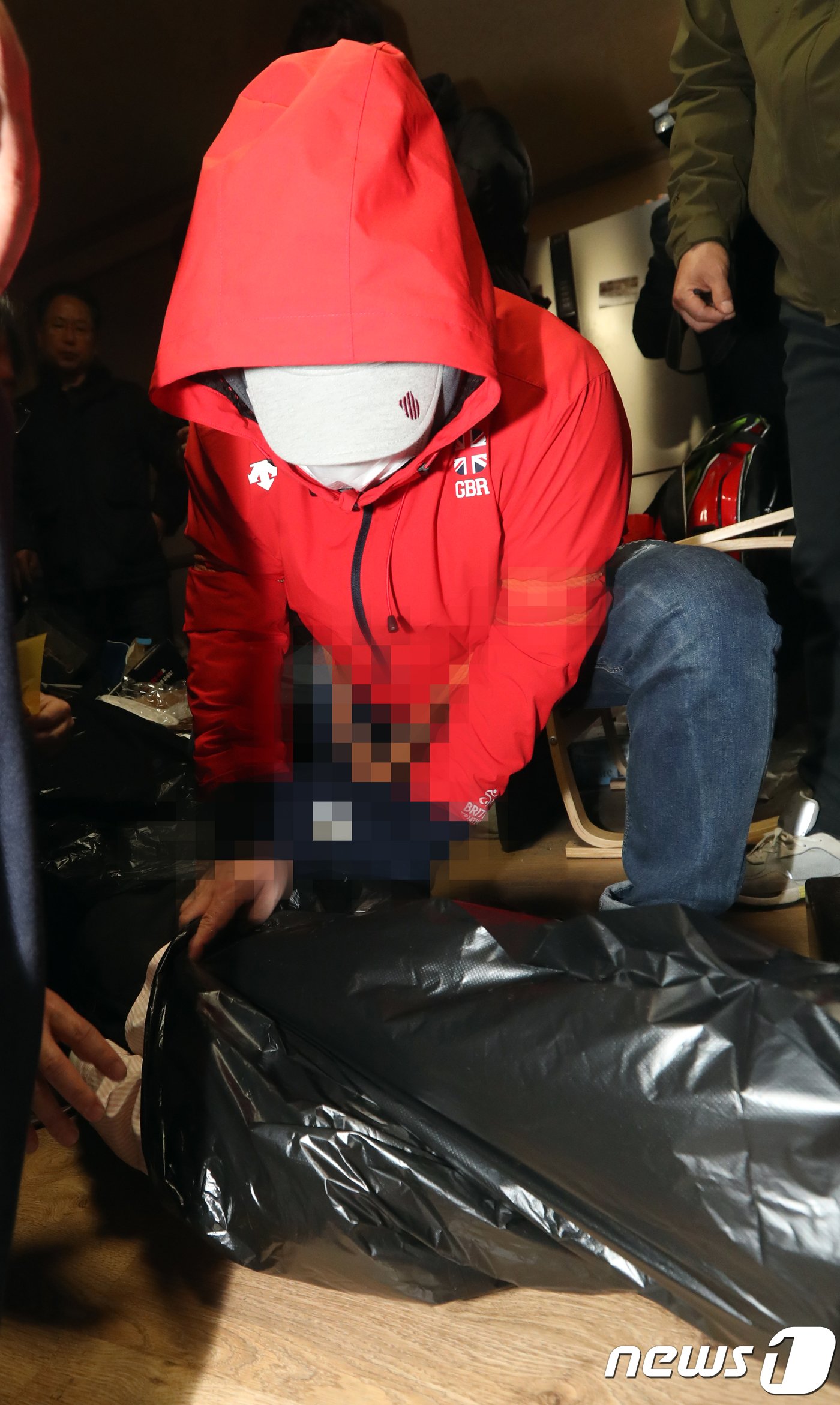 본문 이미지 - 동료를 살해한 환경미화원  A 씨가 2018년 3월 21일 전북 전주시 본인이 거주하던 원룸에서 열린 현장검증에서 동료를 살해 후 시신을 검정비닐로 싸는 모습을 재현하고 있다.2018.3.21/뉴스1 ⓒ News1 사진공동취재단