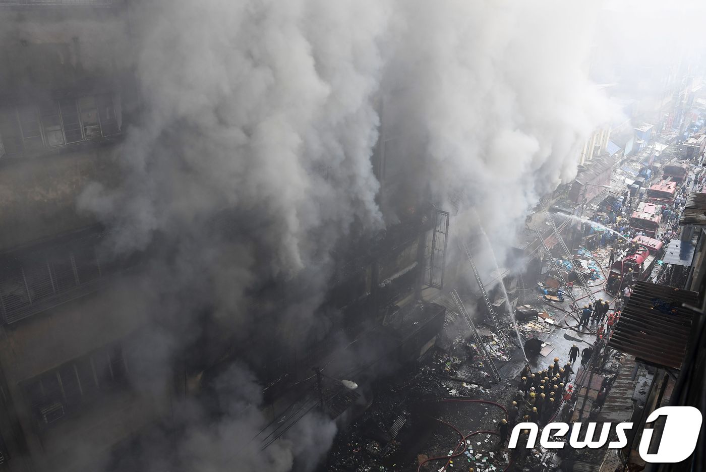 (콜카타 AFP=뉴스1) 우동명 기자 = 16일 (현지시간) 인도 콜카타의 도매시장 건물에서 화재가 발생해 소방대원들이 불을 끄고 있다.ⓒ AFP=뉴스1