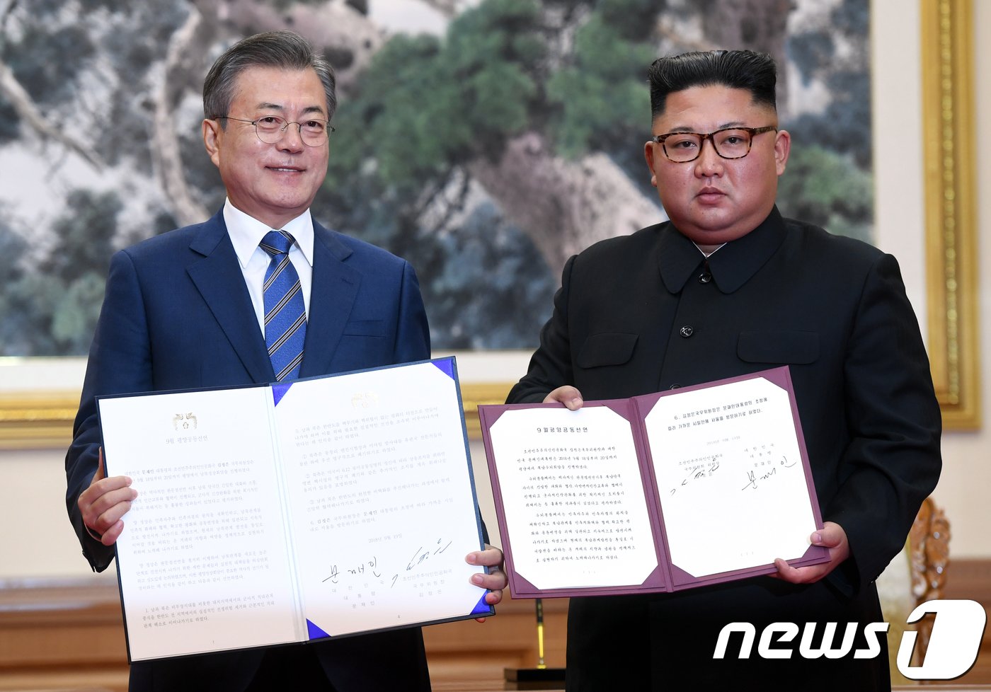 본문 이미지 - 문재인 대통령과 김정은 국무위원장이 19일 오전 평양 백화원 영빈관에서 평양공동선언문에 서명한 후 합의서를 들어보이고 있다. 2018.9.19/뉴스1 ⓒ News1 평양사진공동취재단