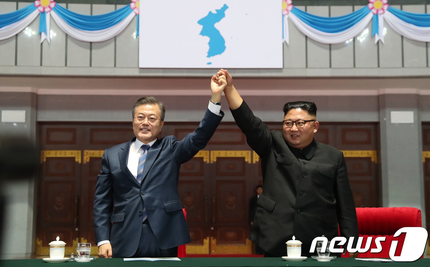 본문 이미지 - 2018년 9월19일 문재인 당시 대통령(왼쪽)과 김정은 북한 조선노동당 총비서가 평양 5.1 경기장에서 열린 '빛나는 조국'을 관람한 뒤 환호하는 평양 시민들에게 손을 들어 인사하고 있다. 2018.9.19/뉴스1 ⓒ News1 평양사진공동취재단