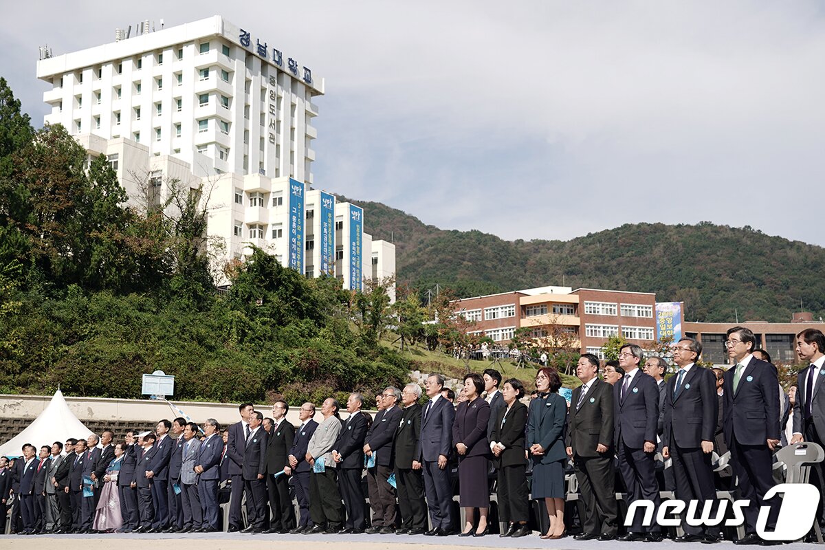 본문 이미지 - 문재인 대통령과 부인 김정숙 여사가 16일 경남 창원시 마산합포구 경남대학교에서 열린 제40주년 부마민주항쟁 기념식에서 참석자들과 우리의 소원을 제창하고 있다. (청와대 제공) 2019.10.16/뉴스1