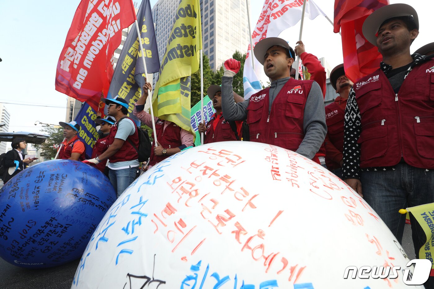 본문 이미지 - 지난 2019년 10월 20일 오후 서울 중구 파이낸스센터 앞에서 열린 전국이주노동자대회에서 참가자들이 이동의 자유와 노동허가제 쟁취 등의 구호를 담은 공을 굴리며 청와대 방향으로 행진하고 있다. 네팔과 방글라데시, 스리랑카, 베트남 등에서 온 이주노동자들은 위험한 현장에서 일하고 있지만 스스로 사업장을 옮길 수 없다며 일터를 옮길 수 있는 이동의 자유를 달라고 촉구했다. 2019.10.20/뉴스1 ⓒ News1 신웅수 기자