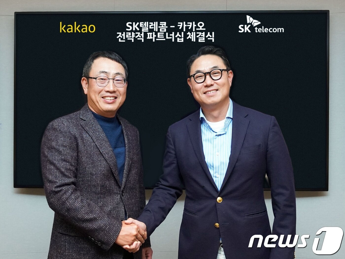 본문 이미지 - 유영상 SK텔레콤 MNO사업부장(왼쪽)과 여민수 카카오 공동대표이사가 악수하는 모습. (SKT 제공) ⓒ 뉴스1