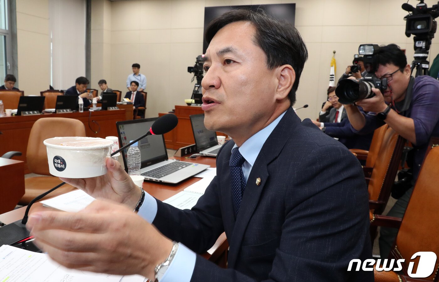본문 이미지 - 김진태 자유한국당 의원이 7일 서울 여의도 국회에서 열린 정무위원회의 국정감사에서 '국대떡볶이'를 들고 질의하고 있다. 김진태 의원은 "가맹사업자들이 공정거래를 방해하는 사회주의 법 때문에 피를 토하고 있다＂고 주장했다. 2019.10.7/뉴스1 ⓒ News1 이종덕 기자