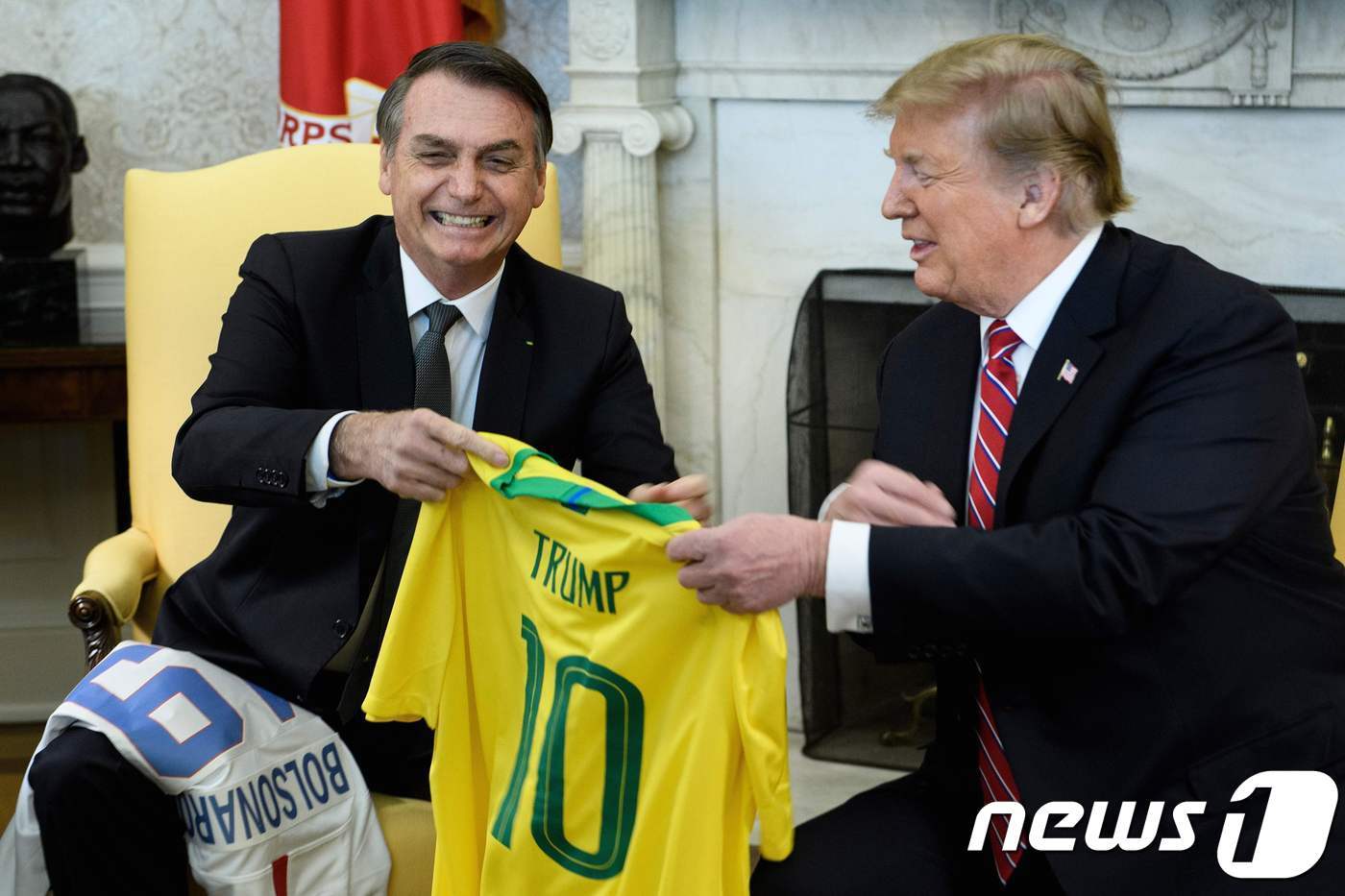 본문 이미지 - 2019년 자이르 보우소나루 당시 브라질 대통령이 워싱턴 백악관에서 도널드 트럼프 미국 대통령과 만나 정상회담을 시작하며 펠레의 등 번호인 &#39;10번&#39; 위에 트럼프의 이름을 적은 브라질 축구 국가대표팀의 노란색 유니폼을 선물로 주고 있다. 2019.03.19 ⓒ AFP=뉴스1 ⓒ News1 우동명 기자