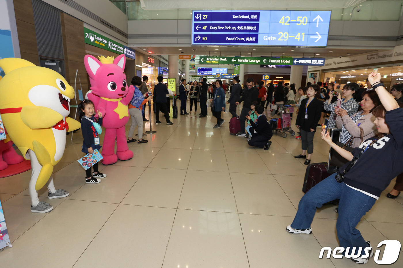 (서울=뉴스1) = 25일 인천공항 1여객터미널 면세지역에 위치한 '바닷속 인천공항 포토존'에서 여객들이 핑크퐁 및 아기상어 캐릭터 인형과 기념촬영을 하고 있다. (인천공항 제공) …