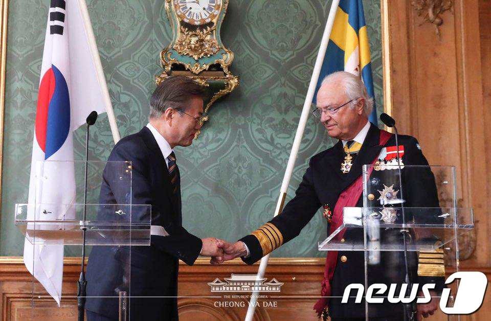 (서울=뉴스1) = 스웨덴을 국빈 방문 중인 문재인 대통령이 14일 스톡홀름 스웨덴 왕궁에서 언론 인사를 마친 후 칼 구스타프 16세 국왕과 악수하고 있다. (청와대 페이스북)20 …