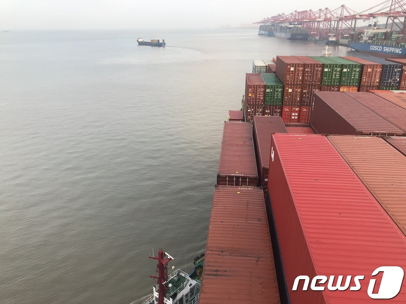본문 이미지 - 23일 오전 중국 상해항 양산터미널로 접안 중인 프로미스호. 예인선(터그보트)이 프로미스호를 밀고 있다. ⓒ 뉴스1 조재현 기자. 
