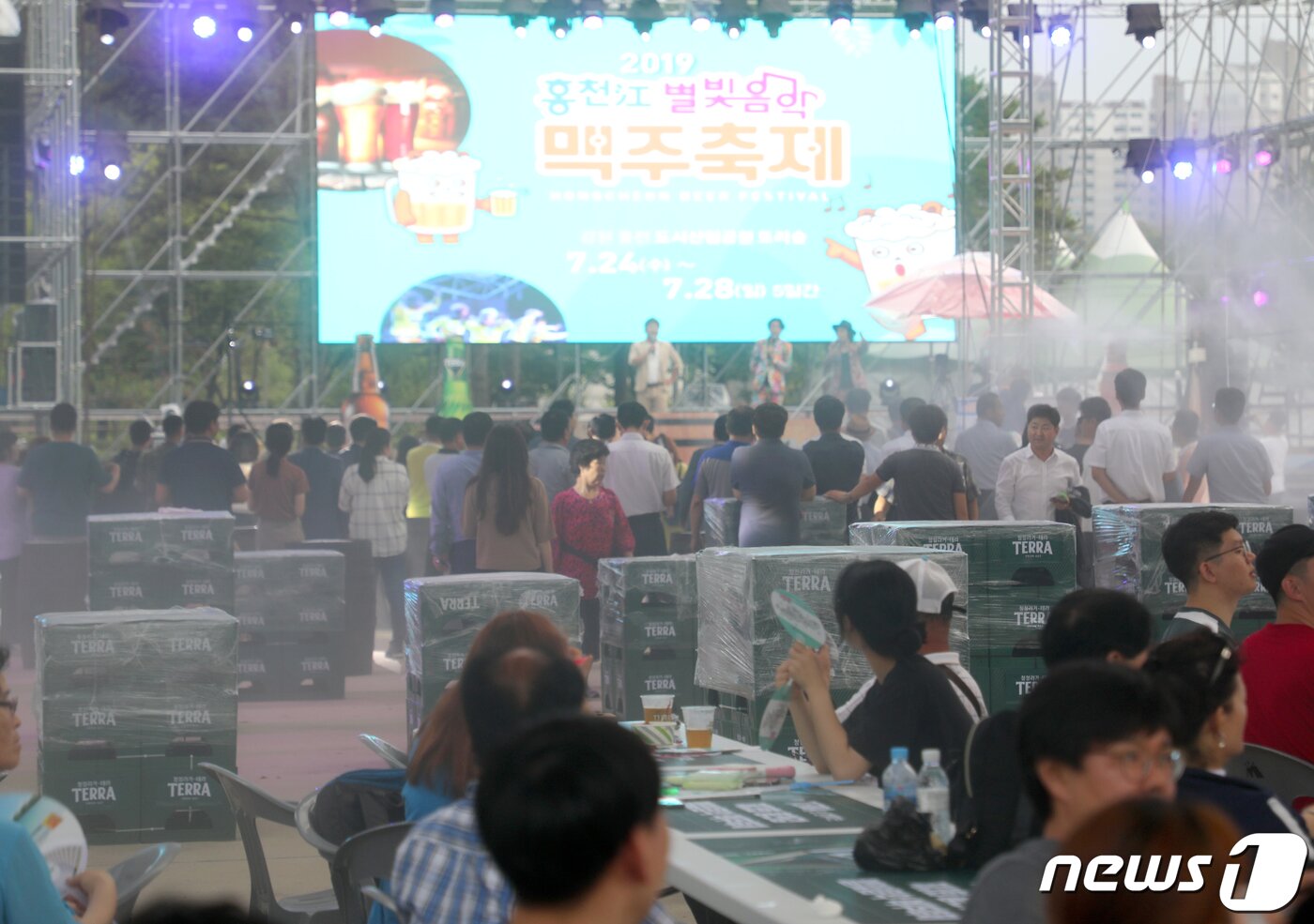 본문 이미지 - 24일 강원 홍천군 토리숲 일대에서 개막한 홍천강 별빛음악 맥주축제에서 관광객들이 맥주를 마시며 개막 공연을 관람하고 있다. 이번 축제는 오는 28일까지 계속된다. 2019.7.24/뉴스1 ⓒ News1 하중천 기자